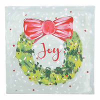 Christmas-themed canvas with a wreath, pink bow, and 'Joy' text on a light blue background.