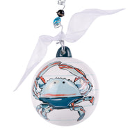 Decorative Christmas ornament with a blue crab design on a white background