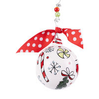 Christmas ornament with candy cane, bow, and snowflake designs on a white background.