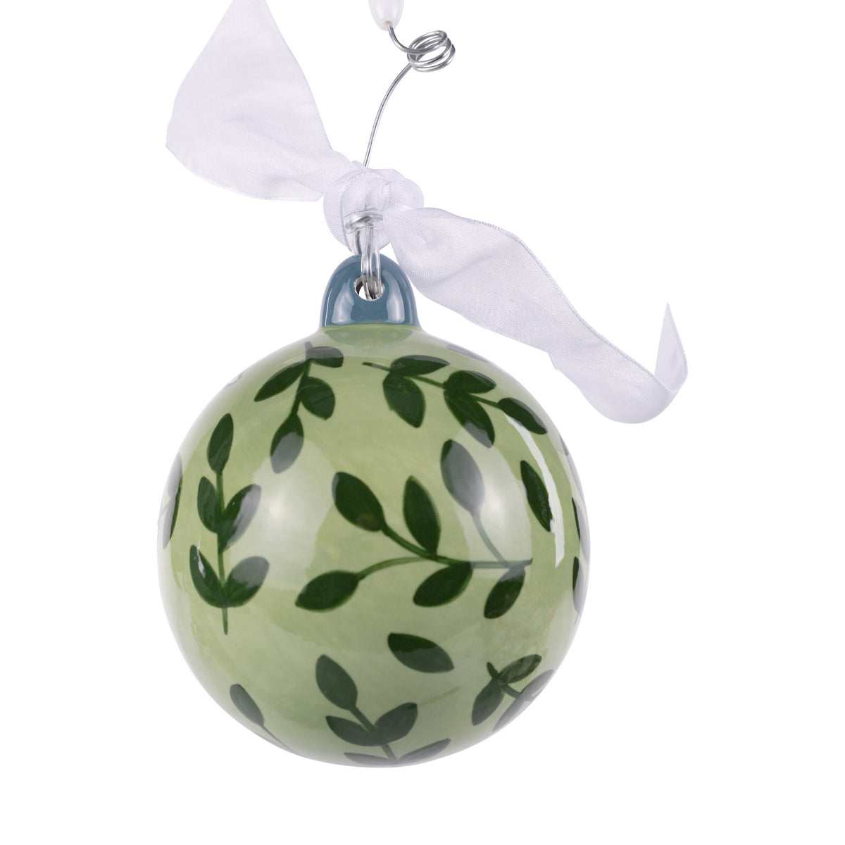 Green glass ornament with leaf pattern on a white background