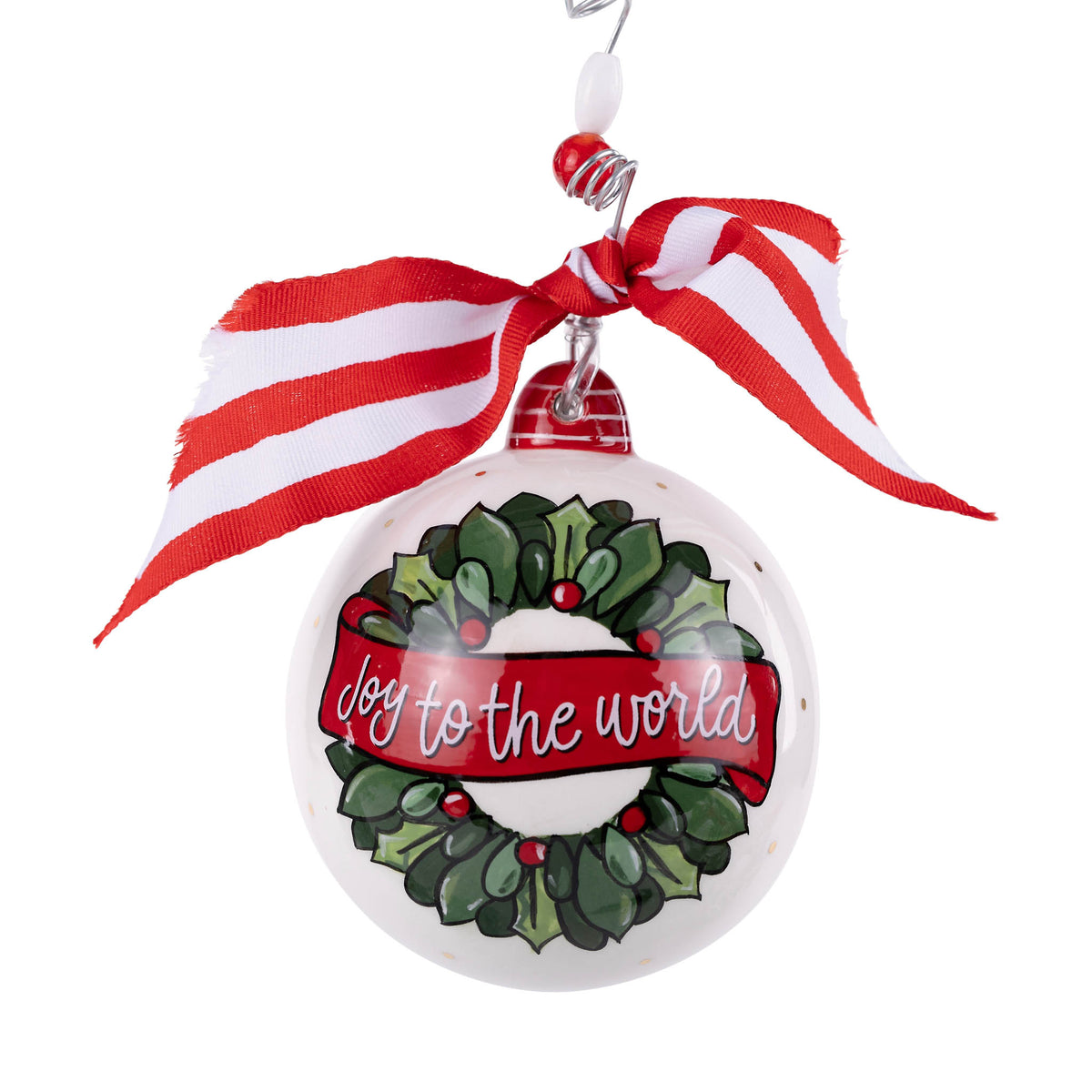 Christmas ornament with wreath design and 'Joy to the World' text, tied with a red and white ribbon.