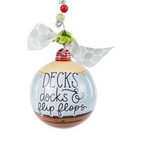 Decorative ornament with 'Decks, docks & flip flops' text on a white background