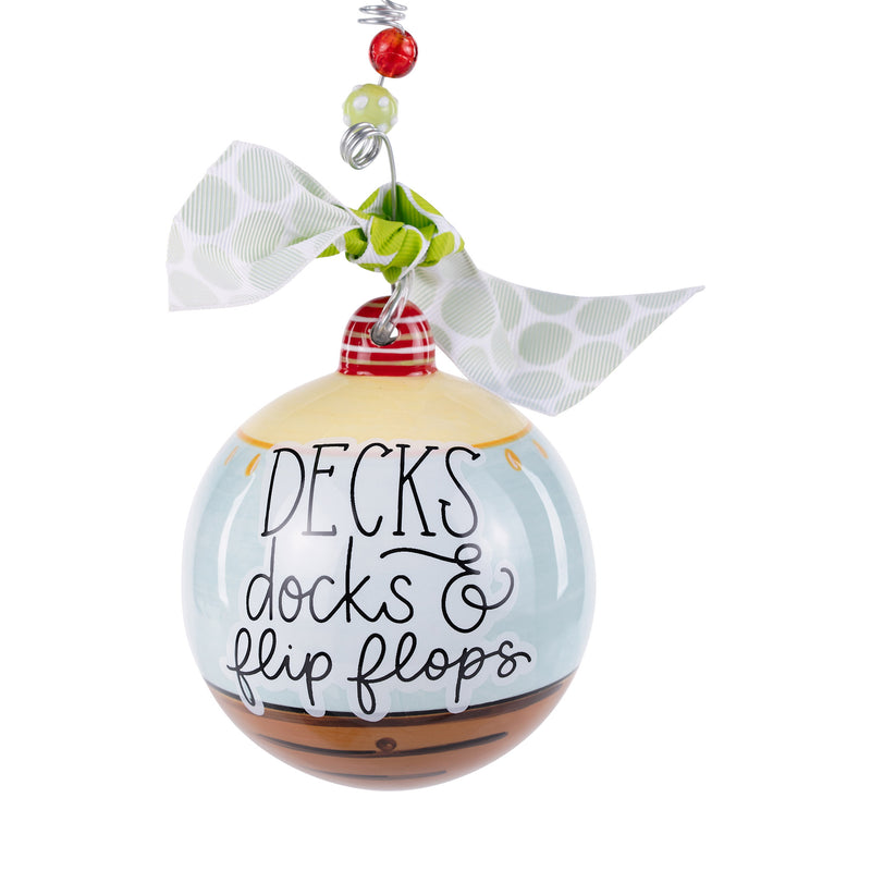 Decorative ornament with 'Decks, docks & flip flops' text on a white background