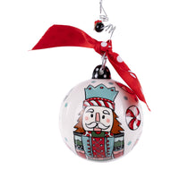 Christmas ornament with a cartoon character wearing a crown and holding a candy cane, attached to a red ribbon.
