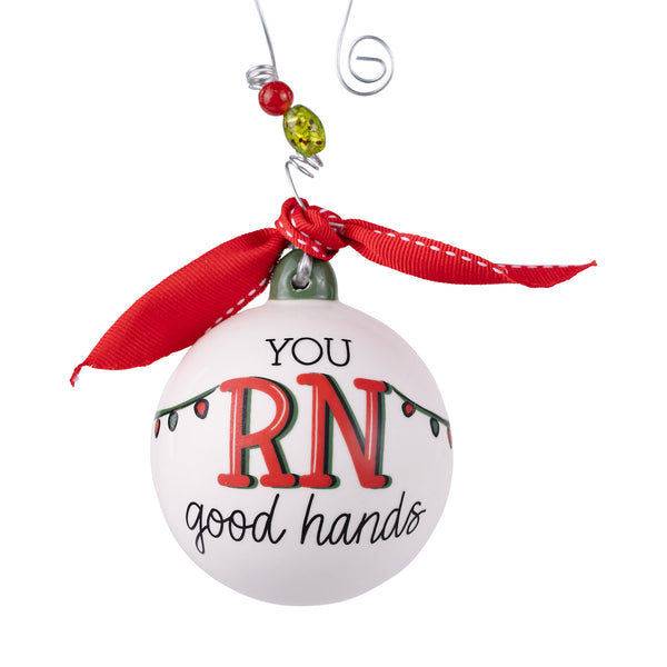 Decorative ornament with 'RN' and 'good hands' text on a white background