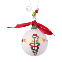 Christmas ornament with caduceus design and red ribbon on a white background