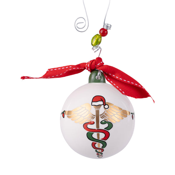 Christmas ornament with caduceus design and red ribbon on a white background