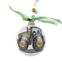 Round ornament with a green tractor design on a white background