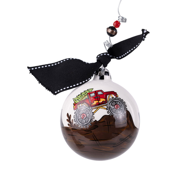 Decorative Christmas ornament with a red truck design on a clear ball, hanging from a ribbon.