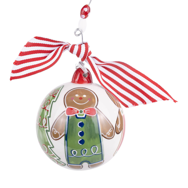 Christmas ornament shaped like a gingerbread man with a red and white striped ribbon on a white background
