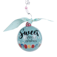 Decorative ornament with 'Sweet Winter Wishes' text on a light blue background