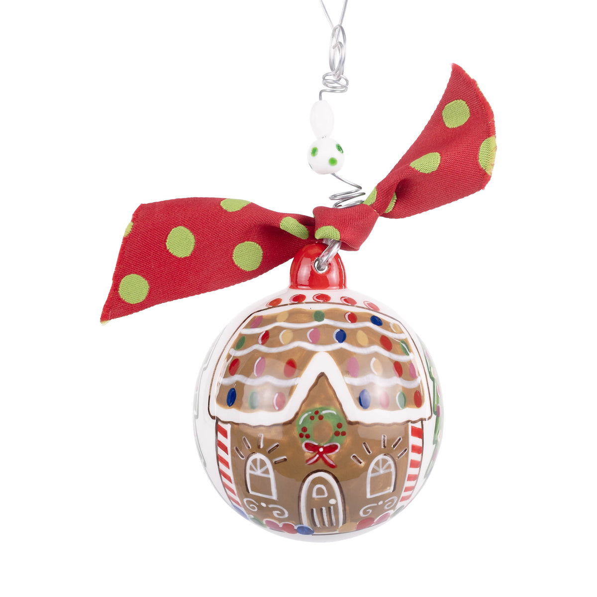 Decorative Christmas ornament shaped like a gingerbread house with a red ribbon on a white background