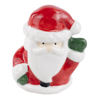 A ceramic charcuterie board topper in the form of Santa Claus wearing a red suit.