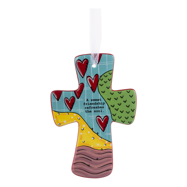 A decorative cross with heart shapes and decorative patterns, featuring the text 'A sweet friendship refreshes the soul'.