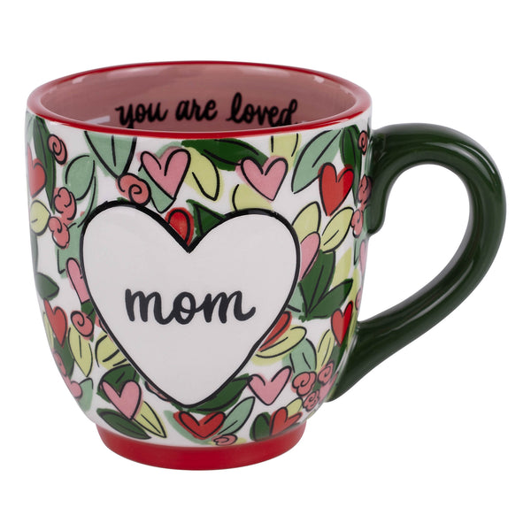 Mug with heart design and 'mom' text on a white background