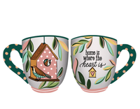 Two mugs with decorative designs and text on a white background