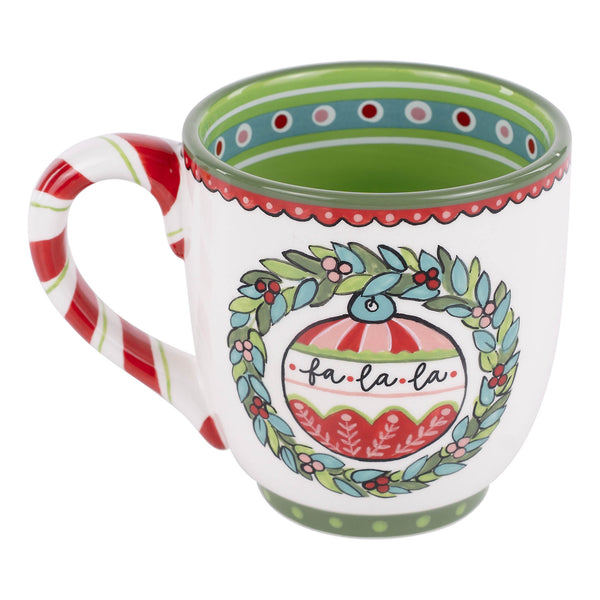 Colorful mug with Christmas design and 'fa la la' text on a white background