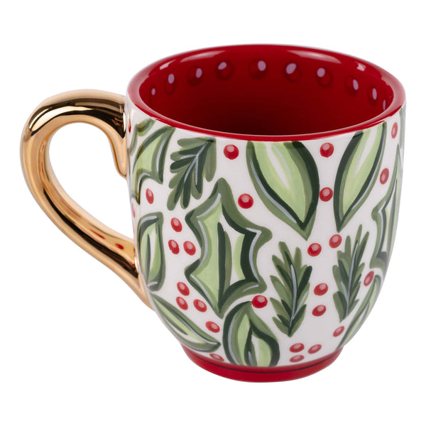 Decorative mug with holly design and gold handle on a white background