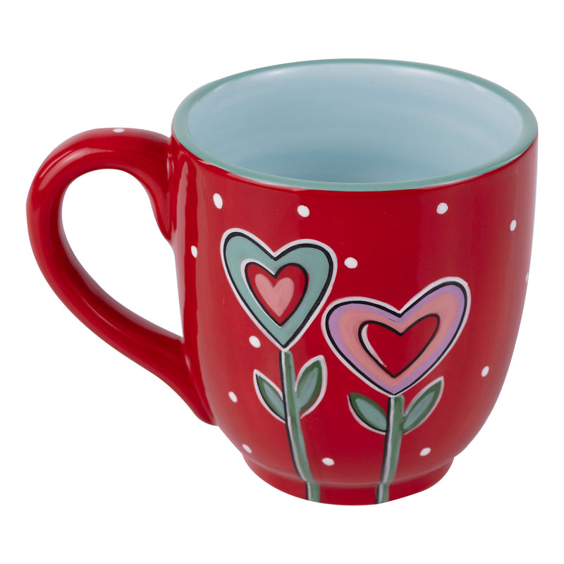 Red mug with heart designs on a white background