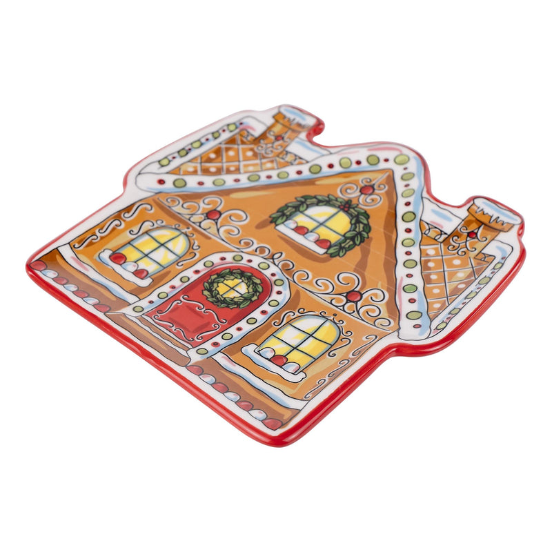 Decorative gingerbread house-shaped plate on a white background