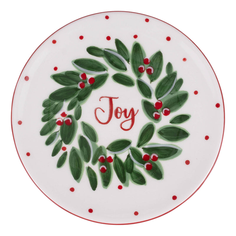 Decorative plate with a green wreath and red berries on a white background