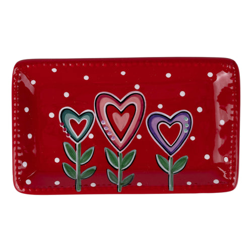 Red rectangular plate with heart-shaped flowers on a white background