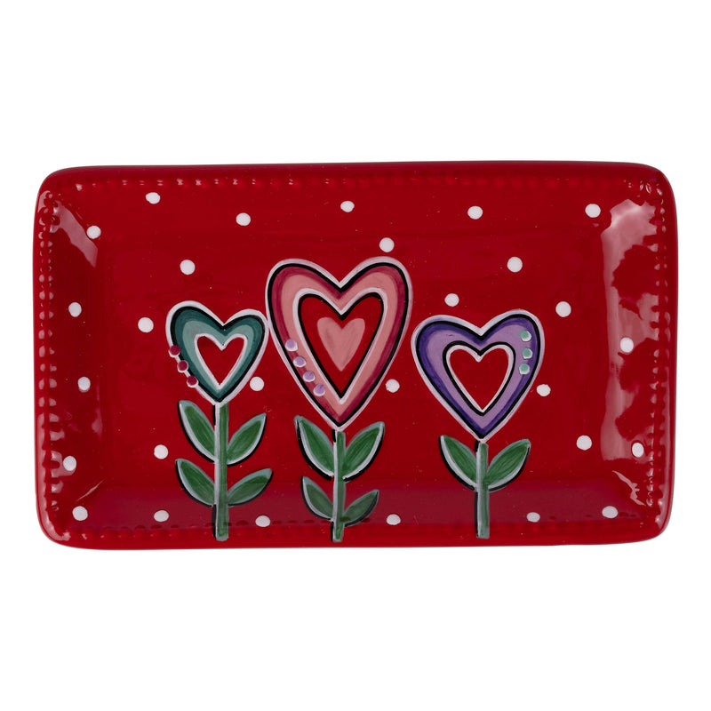 Red rectangular plate with heart-shaped flowers on a white background