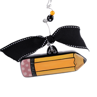 Decorative pencil ornament with a black bow on a white background