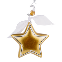 A gold star-shaped ceramic ornament with a shiny finish and a white ribbon attached at the top for hanging.