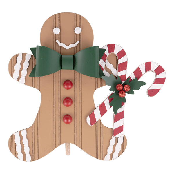 Decorative gingerbread man with candy canes and a bow tie on a white background