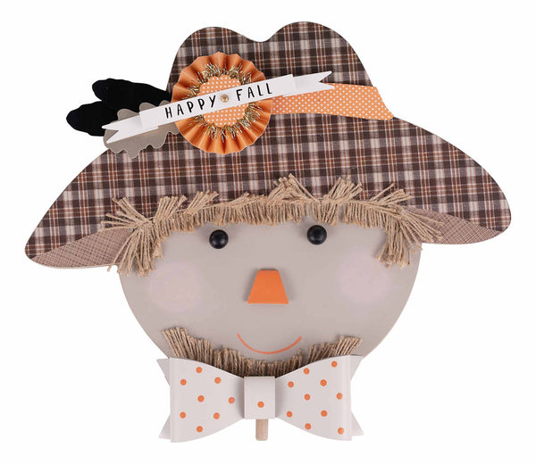 Decorative scarecrow head with plaid hat, bow tie, and 'Happy Fall' sign on a white background