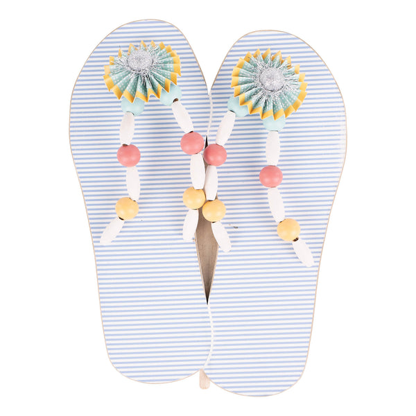 Pair of flip-flops with decorative straps on a white background