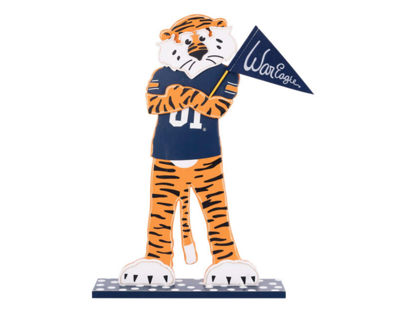 Auburn tiger mascot figurine holding a flag with 'War Eagle' on a white background