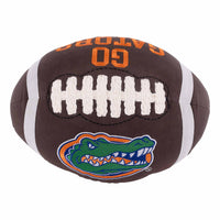 Plush football pillow with Florida Gators logo and text on a white background