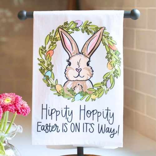 Easter-themed towel with a bunny and wreath design on a white background