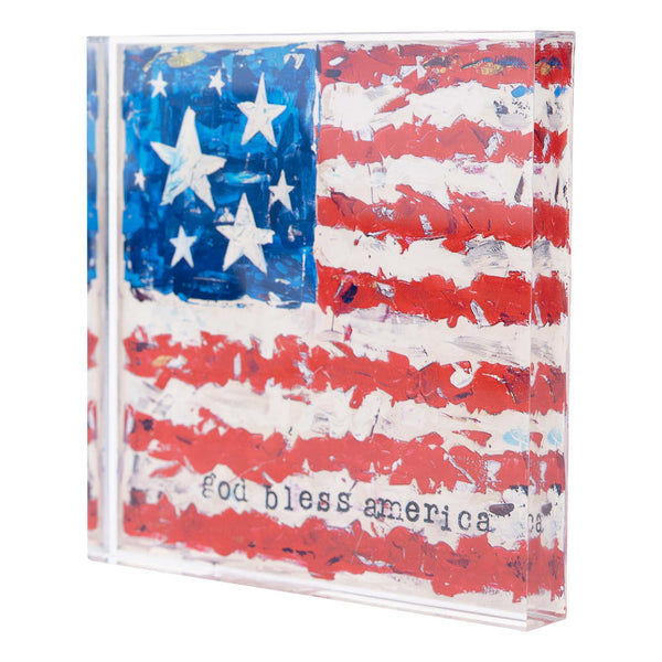 An acrylic stand with a painted design of the American flag and the phrase 'God bless America' written on it.