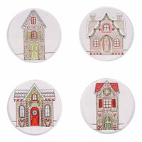 Four round ceramic coasters with gingerbread house designs on a white background