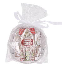Four round ceramic coasters with gingerbread house designs on a white background