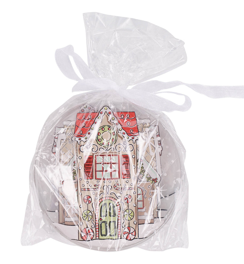 Four round ceramic coasters with gingerbread house designs on a white background