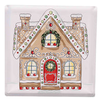 Decorative gingerbread house napkin weight with a wreath on a white background