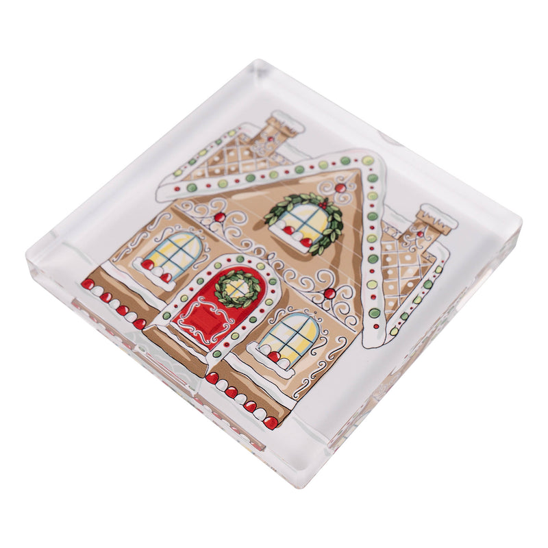 Decorative gingerbread house napkin weight with a wreath on a white background