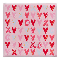 Pink napkin weight with red, pink, and blue heart pattern