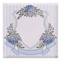 Decorative napkin weight with floral design on a striped background