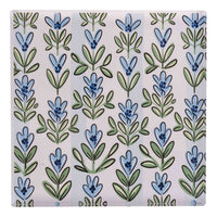 Patterned napkin weight with blue and green floral design on a light background