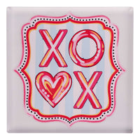 Decorative square napkin weight with 'XO' and heart design on a light blue background