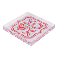 Decorative square napkin weight with 'XO' and heart design on a light blue background