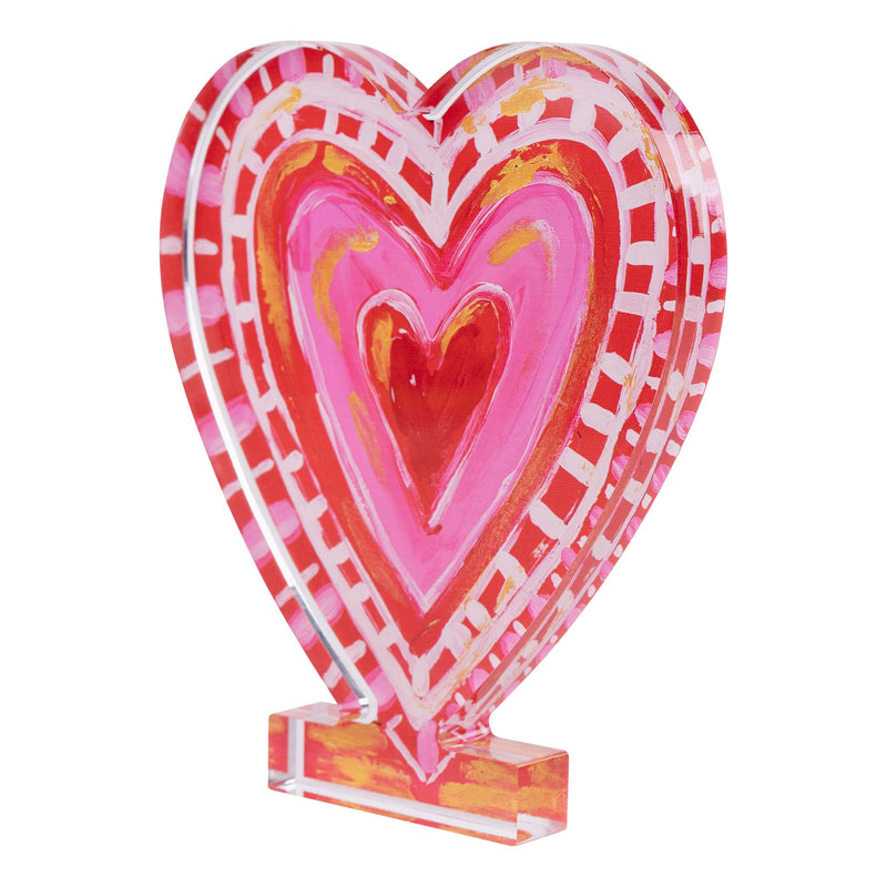 Colorful heart-shaped object with a clear base on a white background