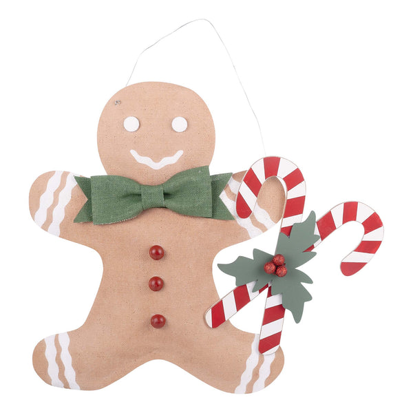 Decorative gingerbread man sign with candy canes and a green bow tie on a white background